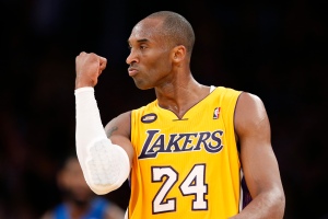 Los Angeles Lakers' Bryant celebrates after his teammate Howard scored during their NBA basketball game against the Dallas Mavericks in Los Angeles